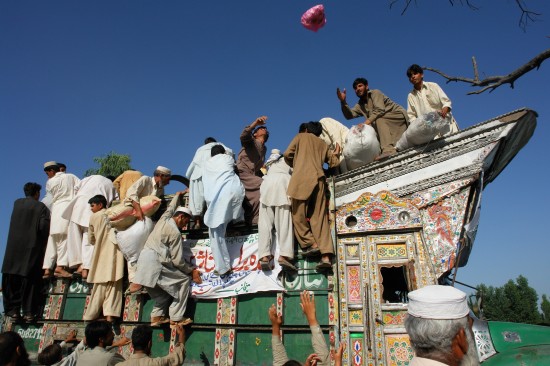 A truck laden with relief goods being ransacked